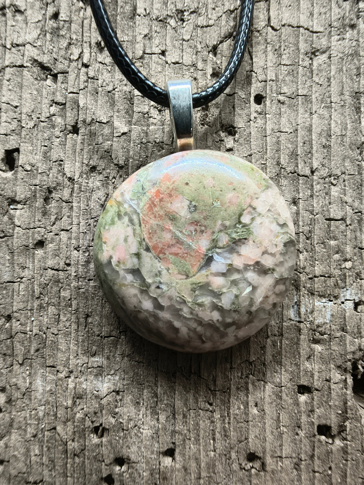 Polished Unakite showing mottled pink feldspar, green epidote, and quartz