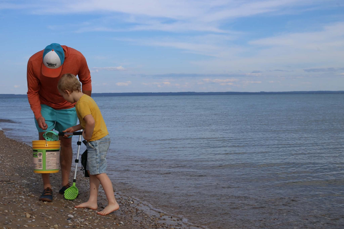 An adult and child walking a Lake Michigan beach